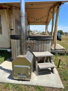 a grill and a picnic table next to a tent at Villa Diana in Merine