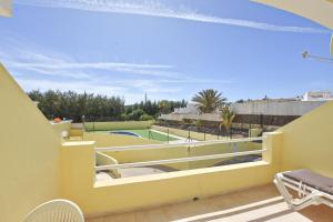 a yellow balcony with a view of a pool at Book Jet - Apartamento Tindaya Wifi & Pool in Costa Calma