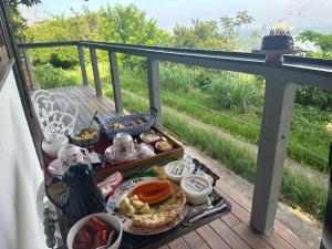 a tray of food on a table on a balcony at Minas Em Marambaia in Rio de Janeiro