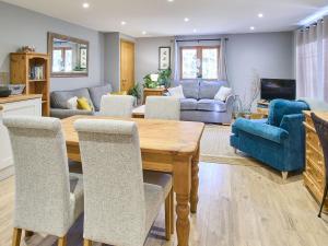 a living room with a wooden table and chairs at Host & Stay - Orchard Barn in Ashford