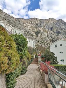 a stairway with houses and mountains in the background at GREEN VILLAGE Apartment in Gornji Orahovac