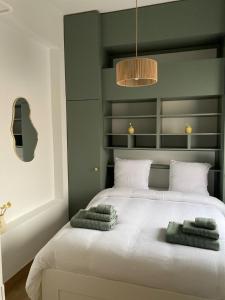 a bedroom with a bed with two towels on it at Pépite in Dinant