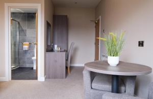 a room with a table and a bathroom with a toilet at Bannview Bed & Breakfast in Portadown