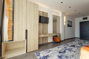 a bedroom with a bed and a dressing room at Continental Hotel in Ulcinj