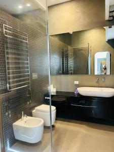a bathroom with a sink and a toilet and a mirror at B&B Boutique in Milan +69 photos
