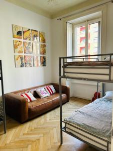 a living room with bunk beds and a couch at Hostel Boutique in Milan