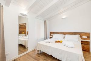 a white bedroom with a large bed with towels on it at Giglio in Volastra +19 photos