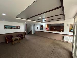 a large waiting room with chairs and a table at Hotel Avanti in Zenica