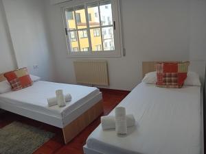 Posteľ alebo postele v izbe v ubytovaní PERLA BLANCA
