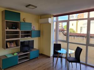 a living room with a table and a television at La Morada del Arcipreste in Guadalajara