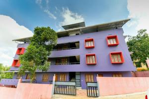 a purple building with red windows at OYO Home Elegant Stay Fine Nest Homes in Kalpetta