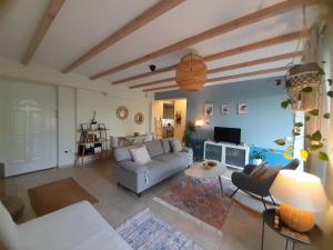 a living room with a couch and a table at Garden by the Sea in Kalamata +5 photos