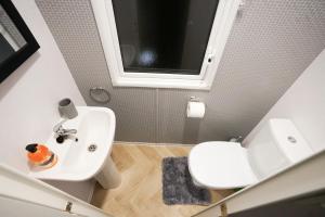a bathroom with a white sink and a toilet at 3-Bed Lodge Sleeps 6 Hot tub in Preston +14 photos