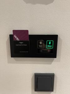 a black box on a wall with a clock on it at OZO Hotels Antares Airport in Hoofddorp