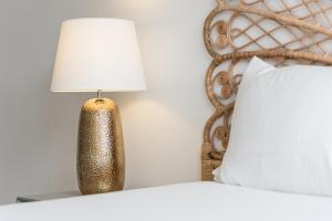 a lamp sitting on a table next to a bed at GuestReady - Mystic Subdual in Porto +14 photos
