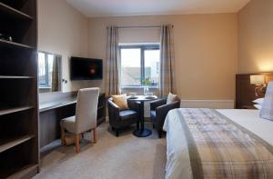 a hotel room with a bed and a desk at Bannview Bed & Breakfast in Portadown