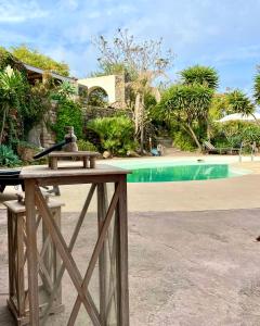 a table with a gun on it next to a pool at Resort La Casa Dei Fiori in Pantelleria