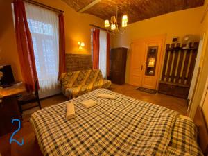 a room with a bed and a couch and a table at Old Town Studio in Braşov