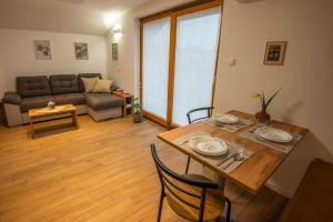 a living room with a table and a couch at Vineyard cottage Majolka in Novo Mesto