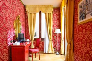 a room with red and yellow curtains and a window at Residenza Ca' San Marco in Venice