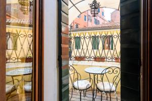 a window view of a table and chairs on a balcony at Residenza Ca' San Marco in Venice