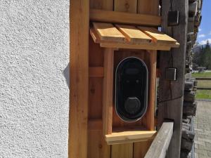 a wooden bird house on the side of a building at Apartments Alp in Bohinj