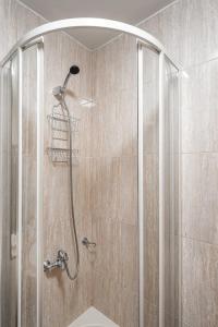 a shower with a shower head in a bathroom at GuestReady - Portrait with a view in Porto
