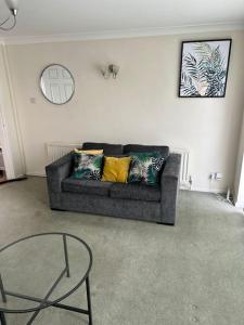 a living room with a couch and a chair at 3 Bed House with free parking in Wolverhampton