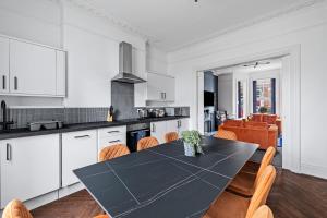 a kitchen and dining room with a table and chairs at Fabulous House in Plymouth in Plymouth