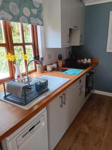 a kitchen with a sink and a counter top at The Barn - Quiet Location in Ashford