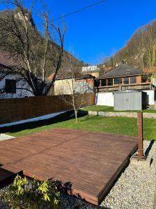 a wooden deck in the backyard of a house at Bungalow Donaublick mit Pool und Garten in Sankt Nikola an der Donau