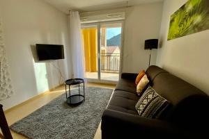 a living room with a couch and a large window at Les Naïades I45 - 2 bedrooms for 5 people ! in Avène