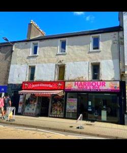 a store on the side of a street at Oban Lorne Apartment in Oban