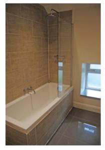 a bathroom with a bath tub with a shower at Oban Lorne Apartment in Oban