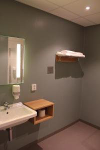 a bathroom with a sink and a mirror at Hotel KRS in Kristiansand