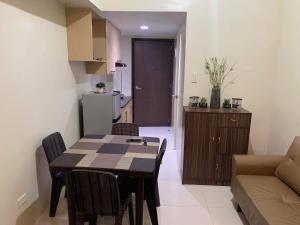 a kitchen and dining room with a table and chairs at Brenthill Condo (Ceramic Unit) in Baguio +2 photos