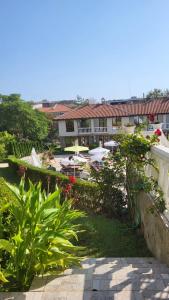 a view of a resort with plants and a building at Студио Костови Имоти in Sveti Vlas