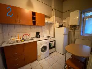 a kitchen with a washing machine and a sink at Old Town Studio in Braşov