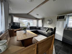 a living room with a couch and a table at Lovely 6 Berth Caravan At Southview Holiday Park Ref 33182s in Skegness