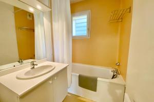 a bathroom with a sink and a bath tub at Les Naïades I47 - 2 bedrooms for 5 people ! in Avène