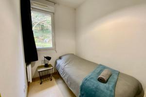 a small bedroom with a bed and a window at Les Naïades I47 - 2 bedrooms for 5 people ! in Avène
