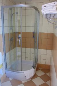 a shower with a glass door in a bathroom at Hotel Dal Kielce in Kielce