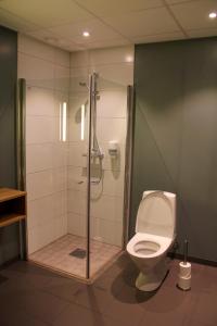 a bathroom with a shower and a toilet at Hotel KRS in Kristiansand