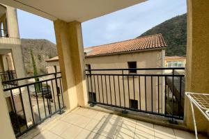 a balcony with a view of a house at Les Naïades I50 - 2 bedrooms for 5 people ! in Avène