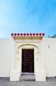 drzwi w białym budynku z czerwonym dachem w obiekcie Jawai Balwant villas w mieście Bijāpur