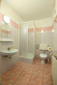 a bathroom with a shower and a toilet and a sink at Willa Świt in Rabka-Zdroj