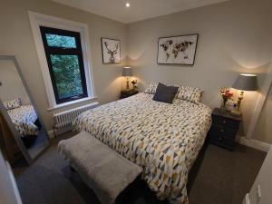 a bedroom with a bed and a window at Newly renovated 2-bed bungalow in Bath