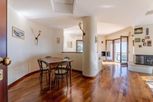 a kitchen and dining room with a table and chairs at L22 Casa Belvedere in Marcelli