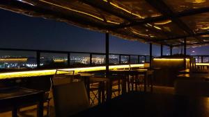a rooftop bar with tables and chairs at night at KADIKÖY BRISTOL HOTEL in Istanbul