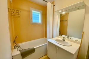 a bathroom with a sink and a tub and a mirror at Les Naïades I52 - 2 bedrooms for 5 people ! in Avène